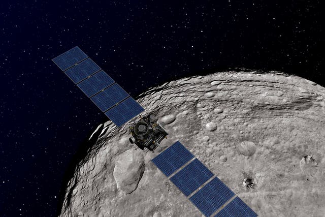 An artist's concept shows NASA's Dawn spacecraft orbiting the giant asteroid Vesta, as released by NASA December 12, 2011.  REUTERS/NASA/JPL-Caltech/Handout