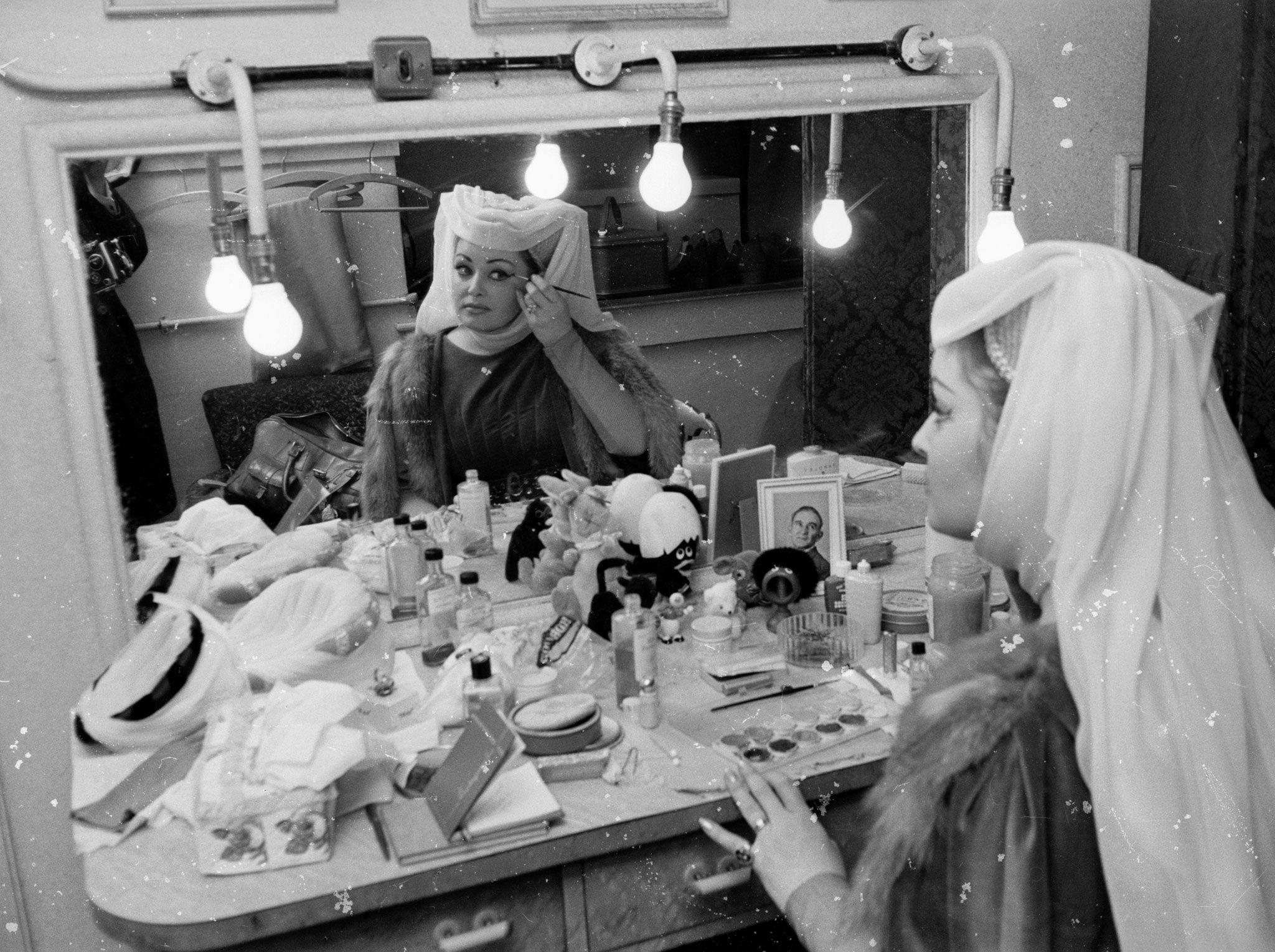 November 1964: Welsh opera singer Gwyneth Jones applying makeup in her dressing room backstage at Covent Garden before her performance in Visconti's production of 'Trovatore'.