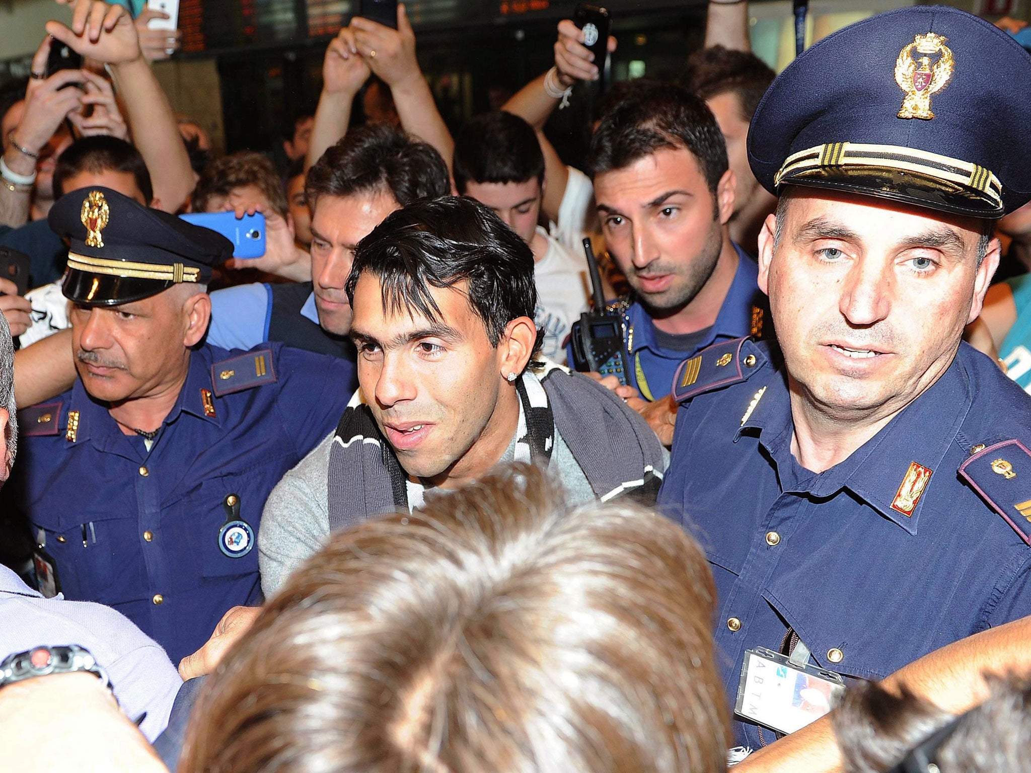 Carlos Tevez arrives at Malpensa airport in Milan