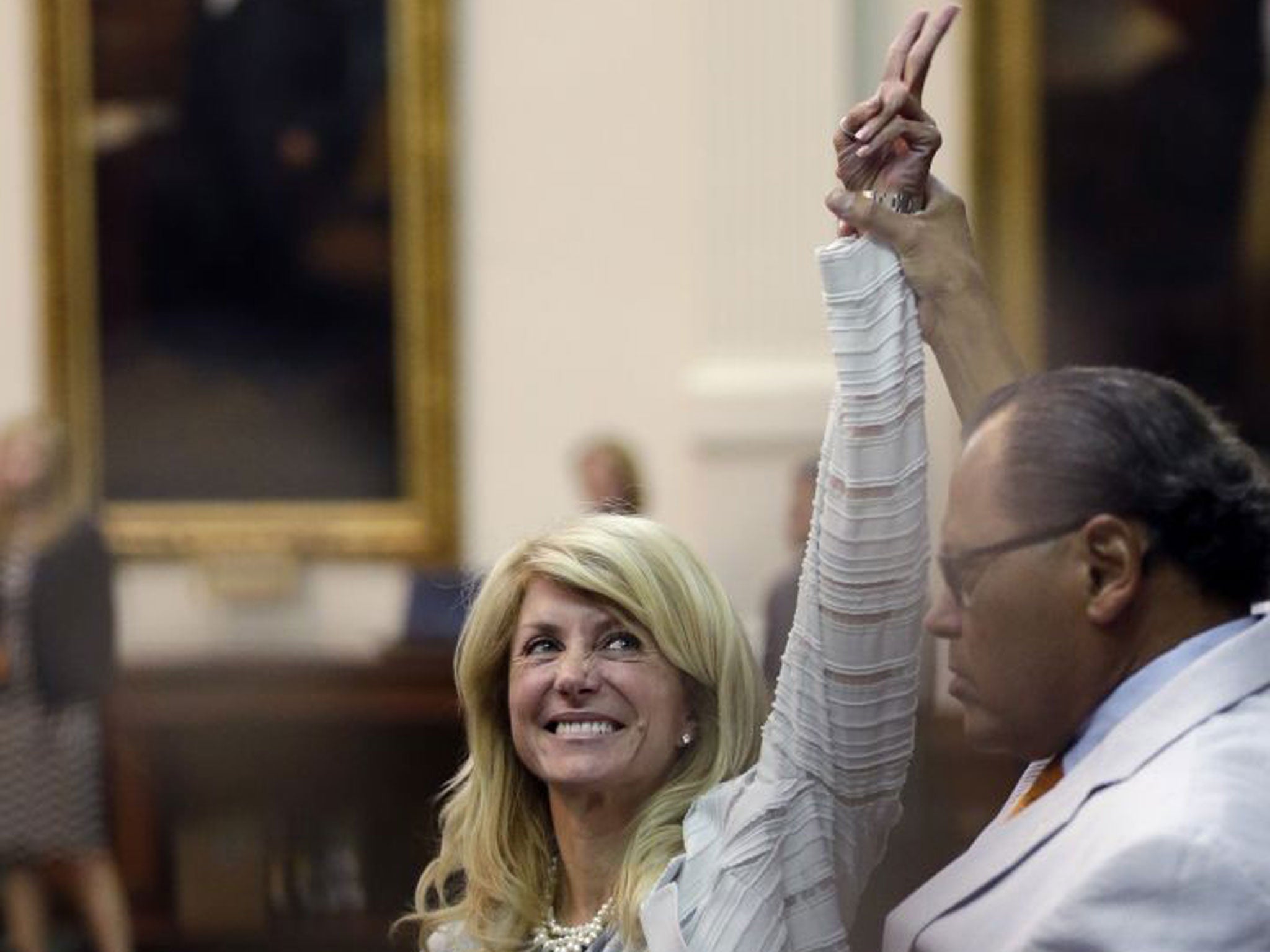 Sen. Wendy Davis, D-Fort Worth, left, who tries to filibuster an abortion bill, reacts as time expires (AP)