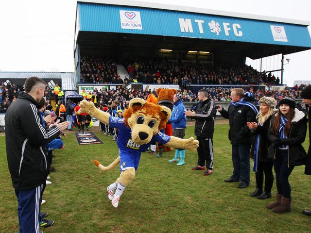 Mascot Roary the Lion leads the teams out ahead at Macclesfield - but the club has dropped plans for a fan to pay for a game