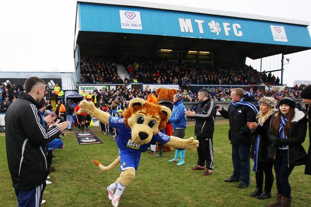 Mascot Roary the Lion leads the teams out ahead at Macclesfield - but the club has dropped plans for a fan to pay for a game