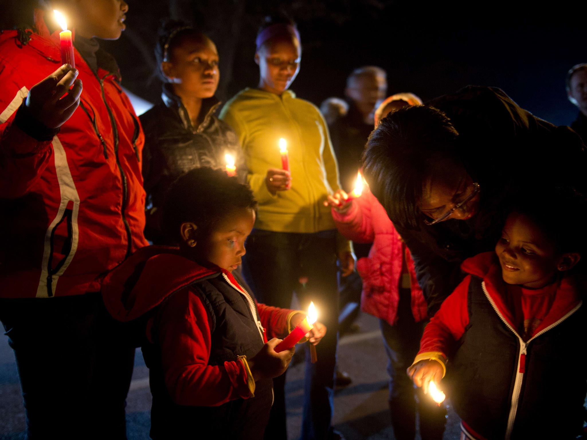 Children take part in a candle lit vigil in support of Nelson Mandela outside the Mediclinic heart hospital in Pretoria