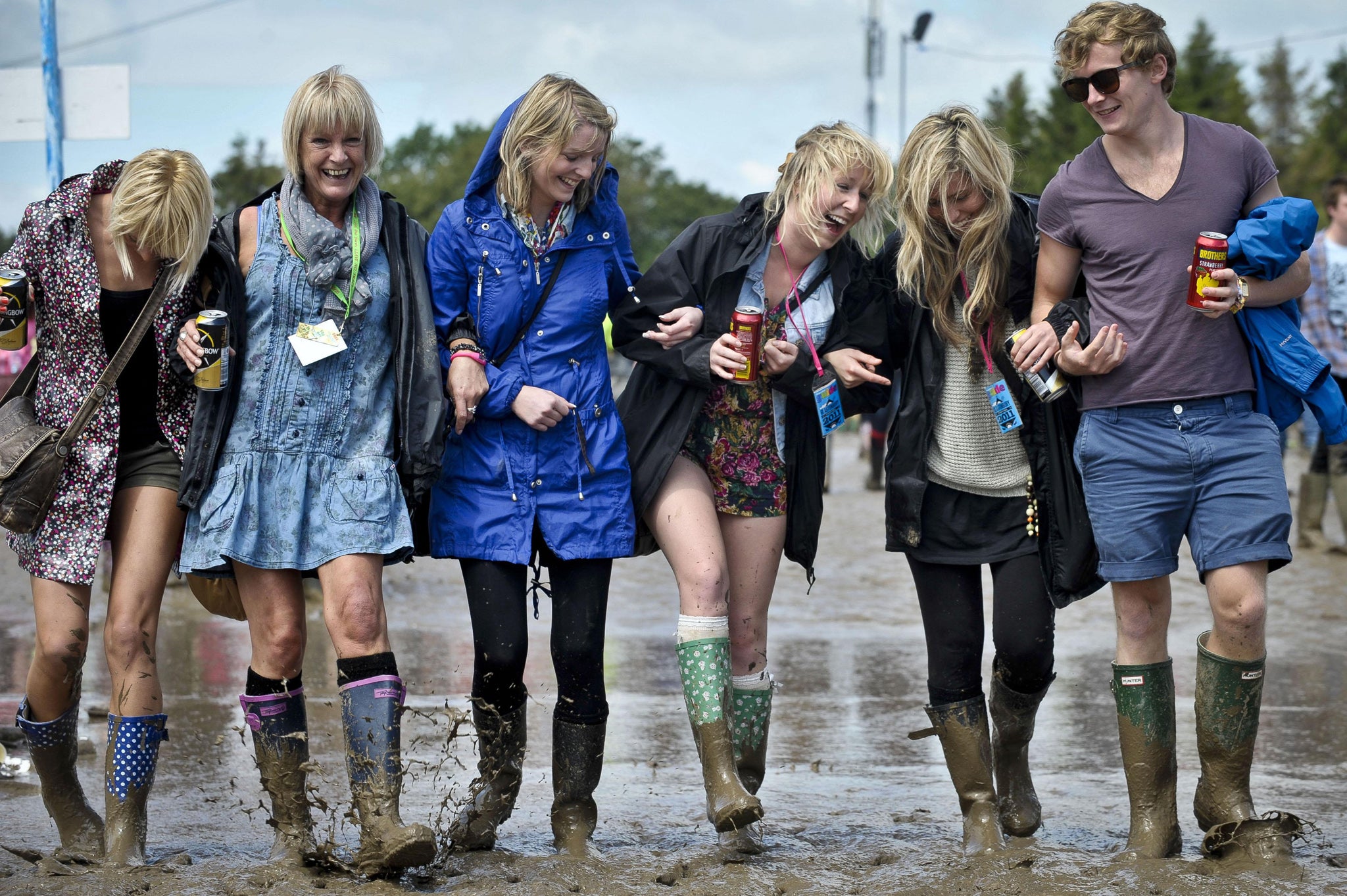 Friends from Torquay splash in the mud at the Glastonbury 2011