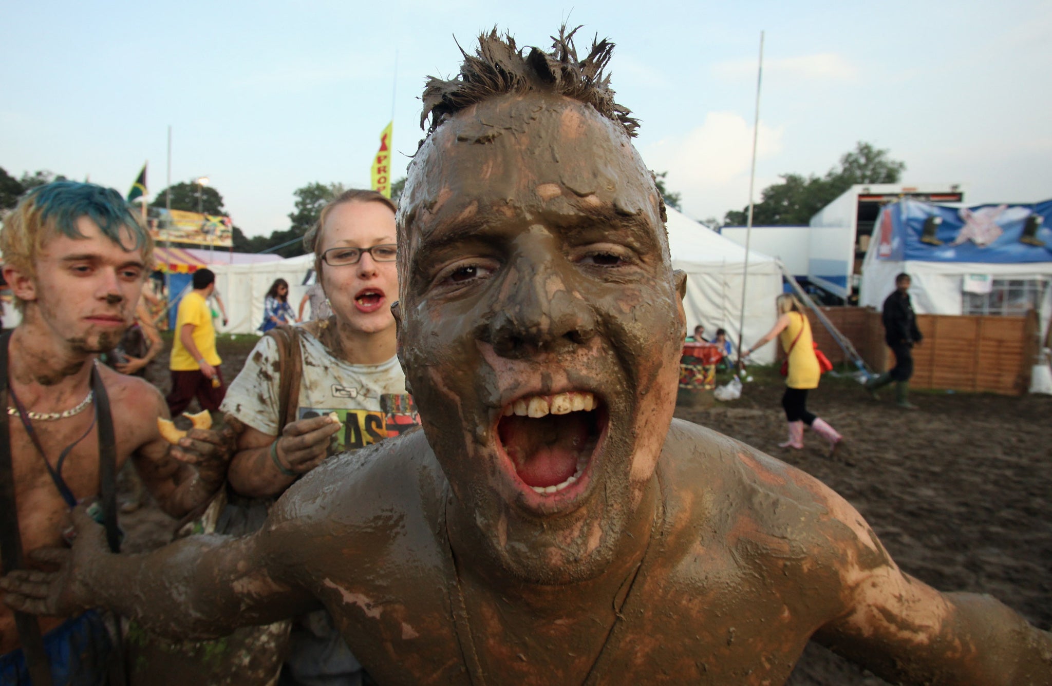 A festival goer gets covered in mud near the main Pyramid Stage at the Glastonbury Festival on June 26, 2009