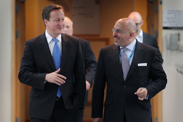 Prime Minister David Cameron (L) walks with Conservative MP Nadhim Zahawi at the Conservative Party Conference during a television interview on October 5, 2010 in Birmingham, England 