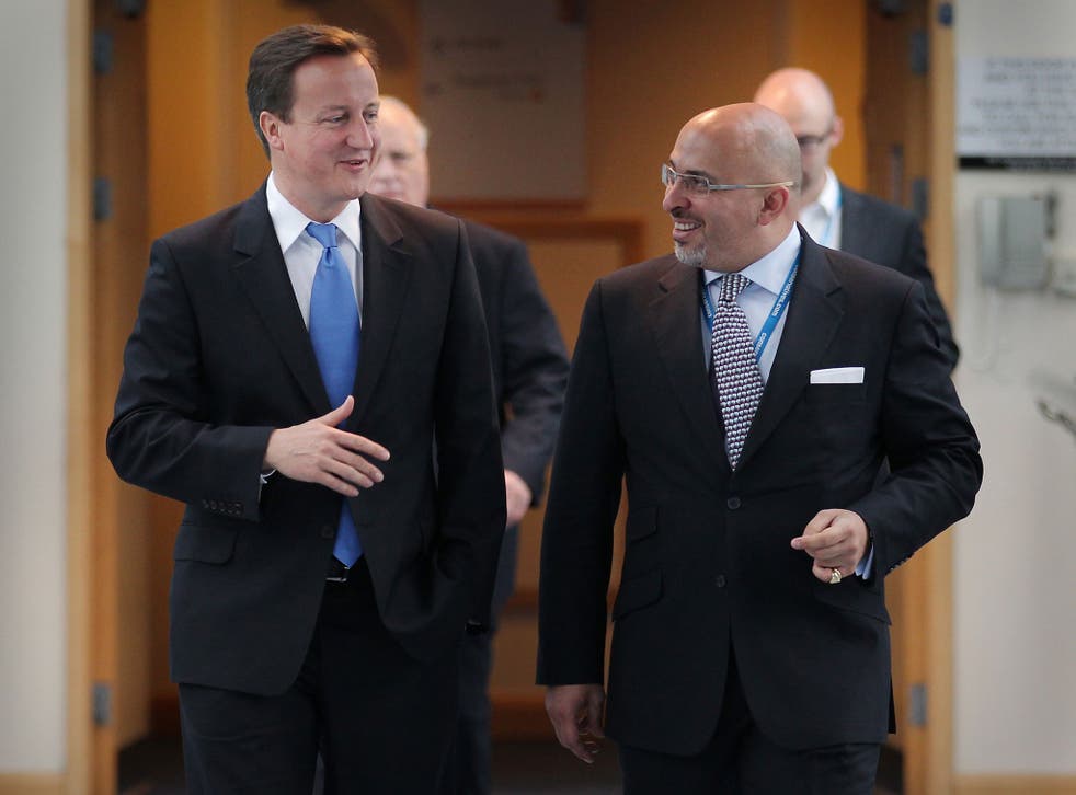 Prime Minister David Cameron (L) walks with Conservative MP Nadhim Zahawi at the Conservative Party Conference during a television interview on October 5, 2010 in Birmingham, England 