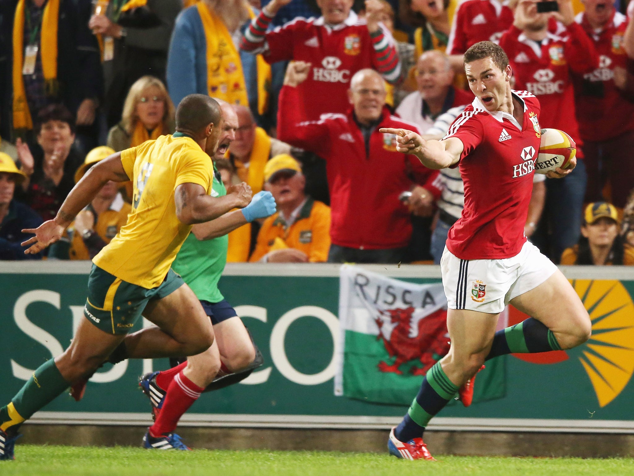 George North of the Lions taunts Will Genia as he breaks clear to score the first Lions try during the First Test match between the Australian Wallabies and the British & Irish Lions