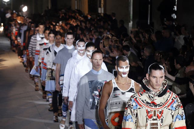 Models presents a creation from the Spring/Summer 2014 Men's Collection by Givenchy fashion house during the Paris Fashion Week