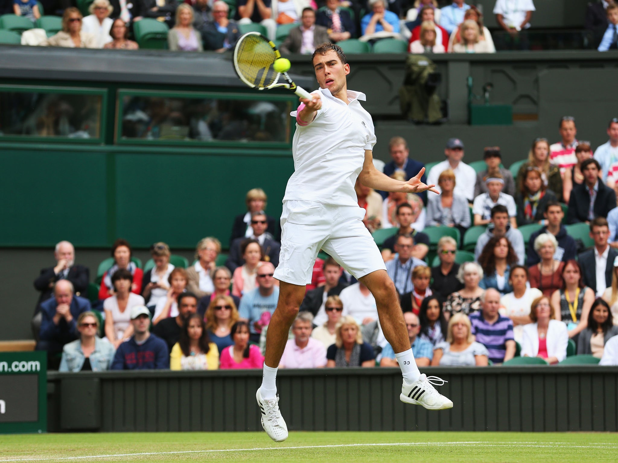 Jerzy Janowicz of Poland hits a forehand during the Gentlemens Singles third round match against Nicolas Almagro