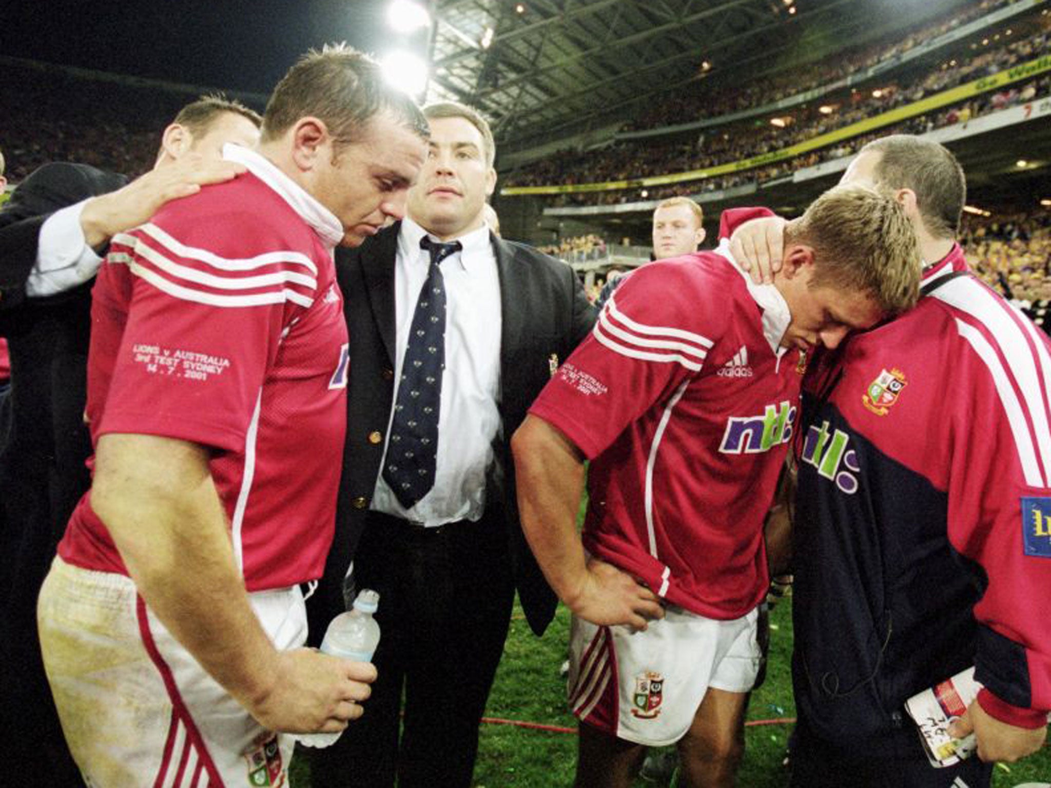 Rob Henderson (far left) and Jonny Wilkinson are consoled after Richard Hill’s injury and Joe Roff’s try helped Australia beat the 2001