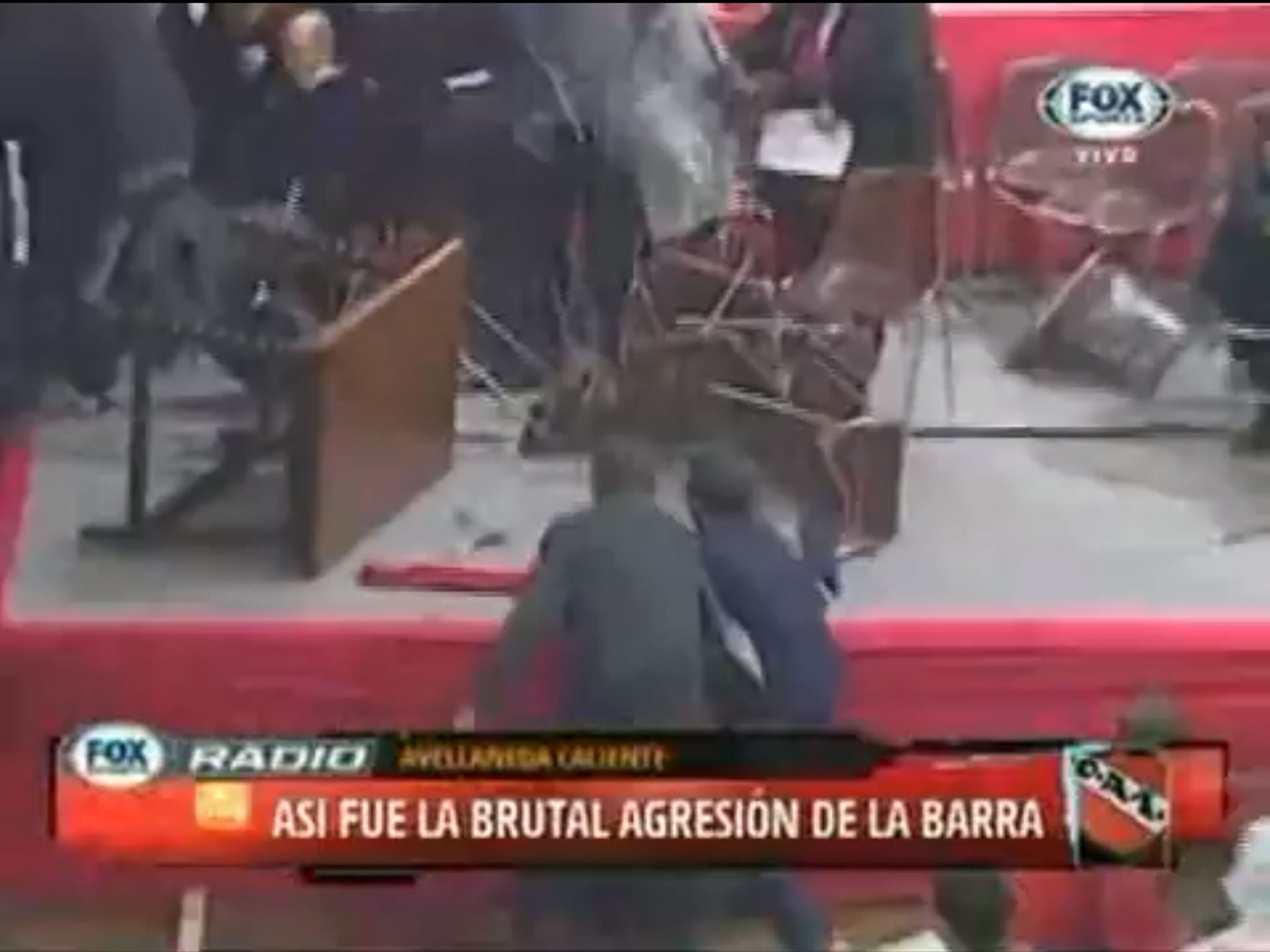 Attack: Supporters bombarded the stage with tables and chairs