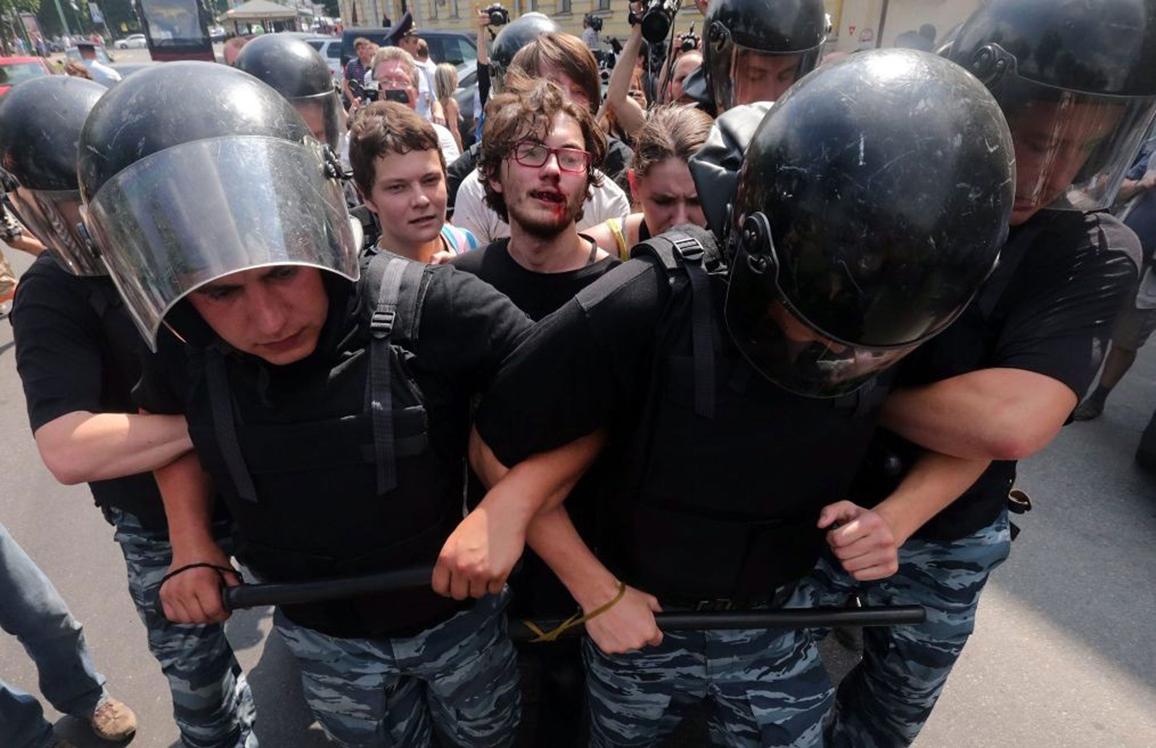 An injured protester clashes with police in Russia during Saturdays gay-rights rally. Photo: EPA