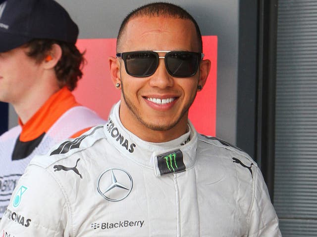 All smiles: Lewis Hamilton celebrates his Silverstone pole