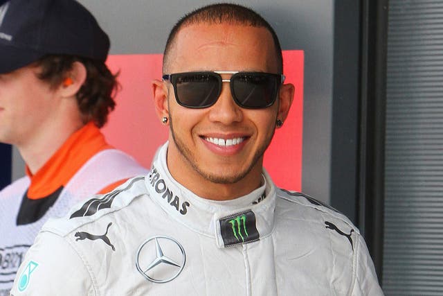 All smiles: Lewis Hamilton celebrates his Silverstone pole