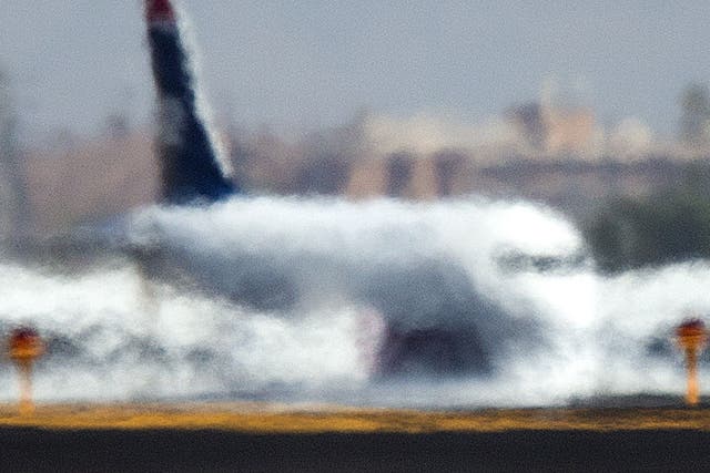 An airliner is distorted by the heat waves rising up from the north runway at Sky Harbor International Airport in Phoenix 