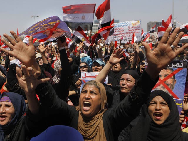 Protesters chant and hold anti-President Morsi posters during a rally in Cairo’s Tahrir Square