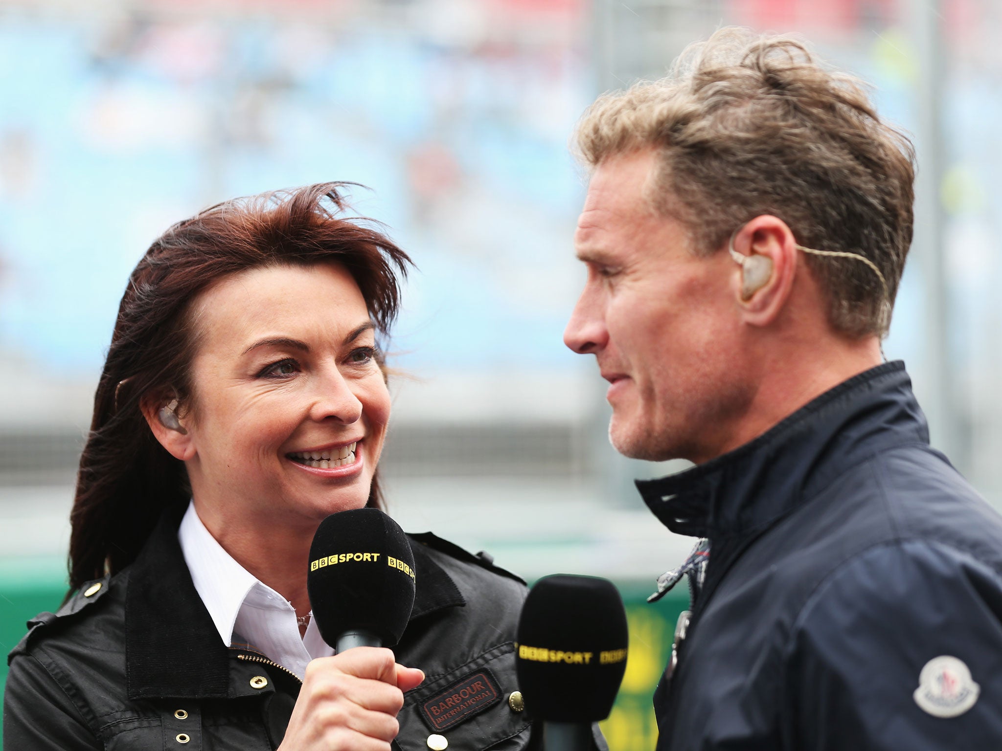 BBC F1 presenter Suzi Perry, left, talks with former F1 driver David Coulthard, right, in the paddock