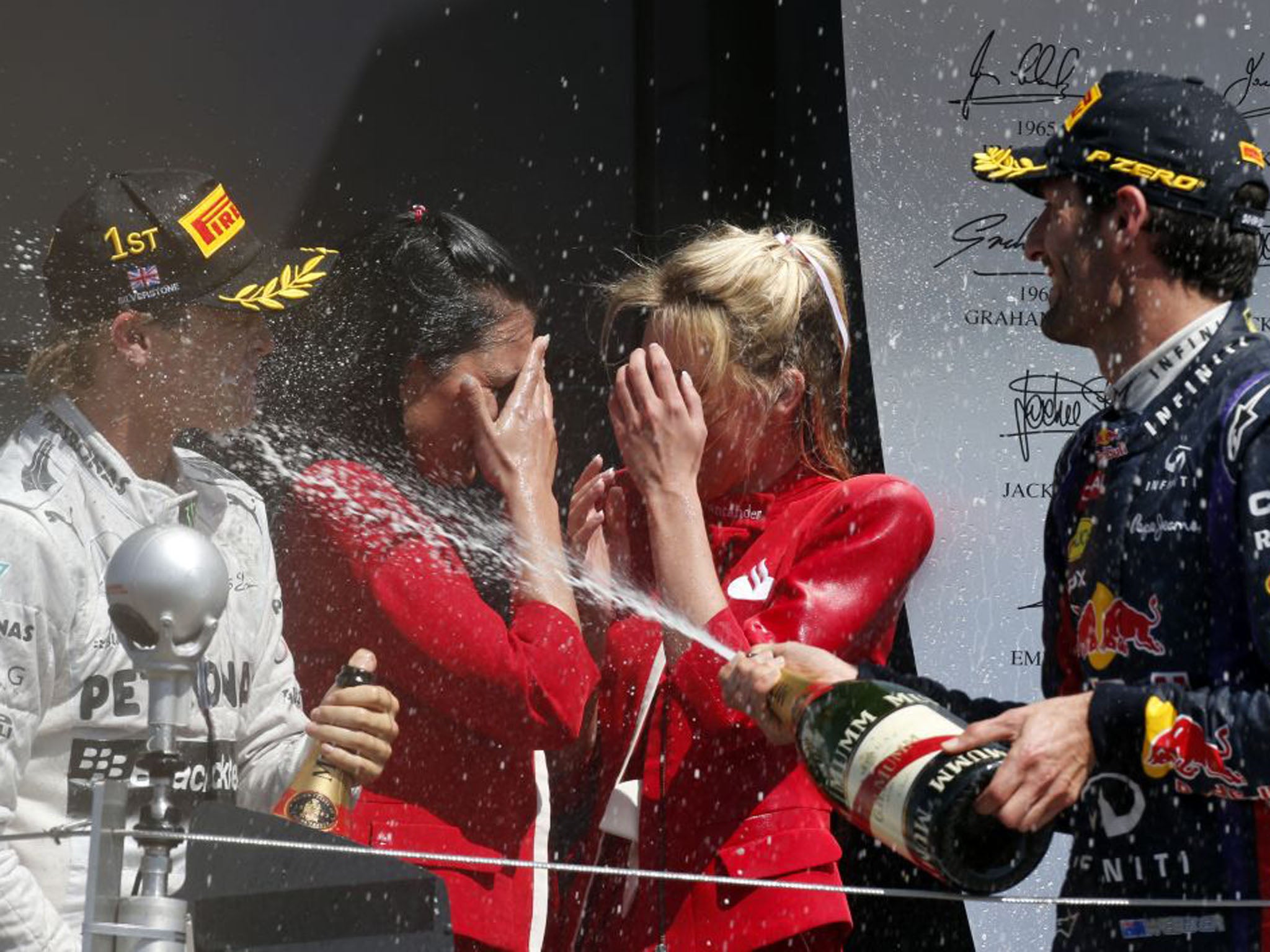Red Bull driver Mark Webber of Australia, right, who finished second, sprays champagne winner, the Mercedes driver Nico Rosberg, with Champagne