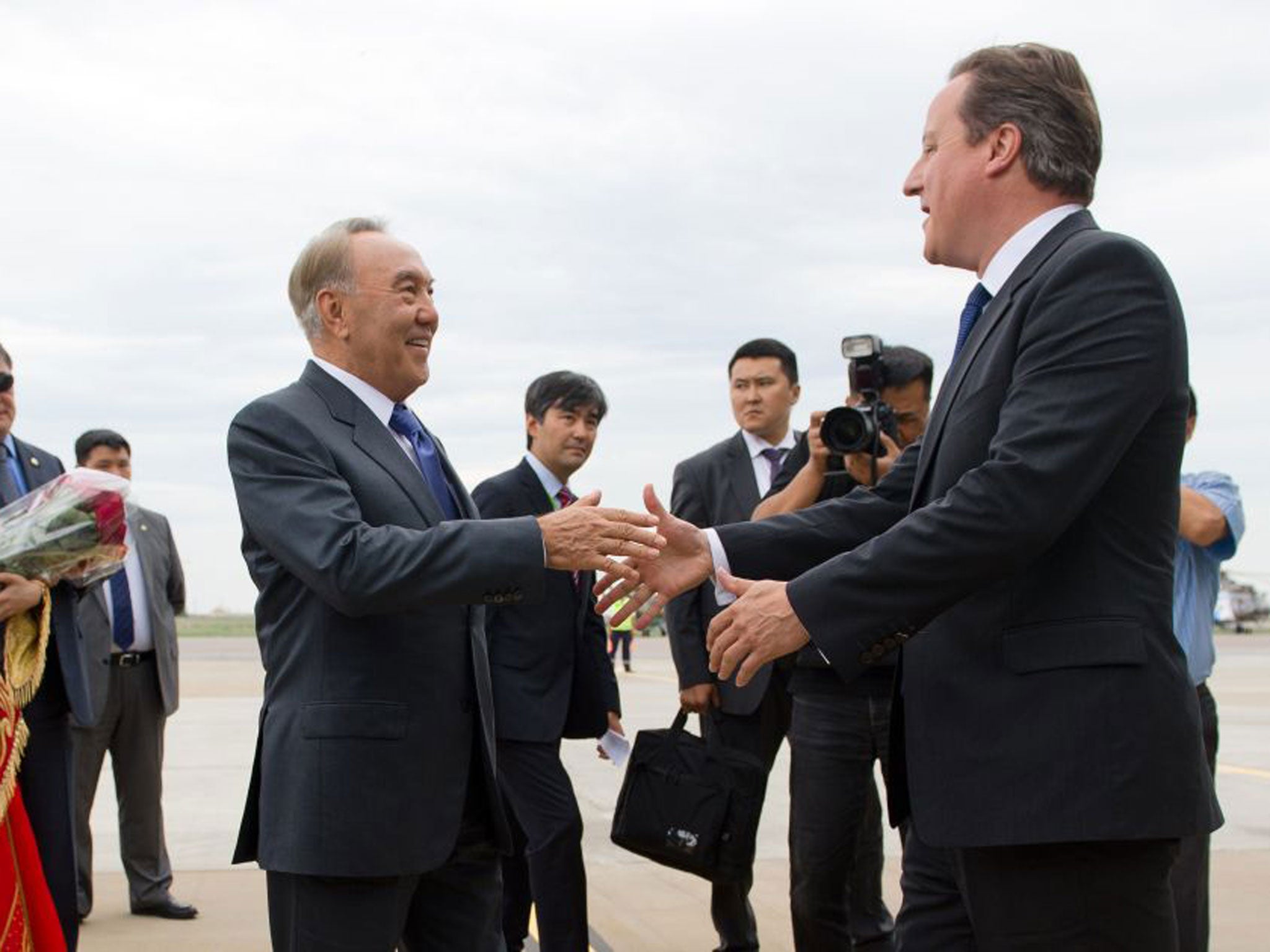 David Cameron is greeted by President Nursultan Nazarbayev after landing at Atyrau airport