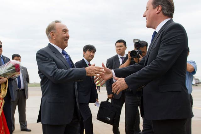 David Cameron is greeted by President Nursultan Nazarbayev after landing at Atyrau airport 