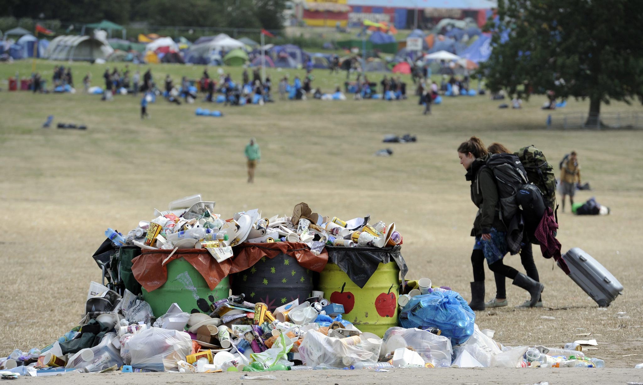 Festival-goers leave Glastonbury Festival as the clean up begins
