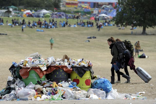 Festival-goers leave Glastonbury Festival as the clean up begins