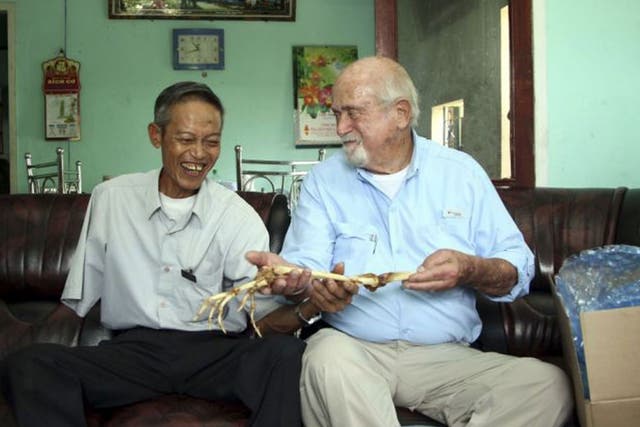 Dr. Sam Axelrad, right, hands over arm bones belonging to former North Vietnamese soldier Nguyen Quang Hung