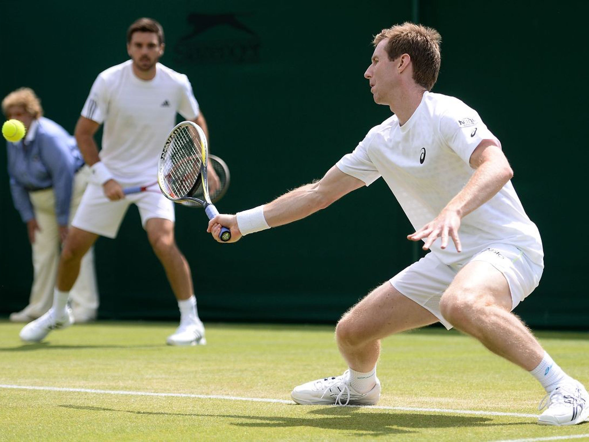 Jonathan Marray plays a forehand next to team-mate Colin Fleming