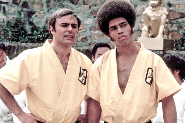 Kelly, right, with John Saxon in ‘Enter The Dragon’; he went on to make 10 films in the next six years