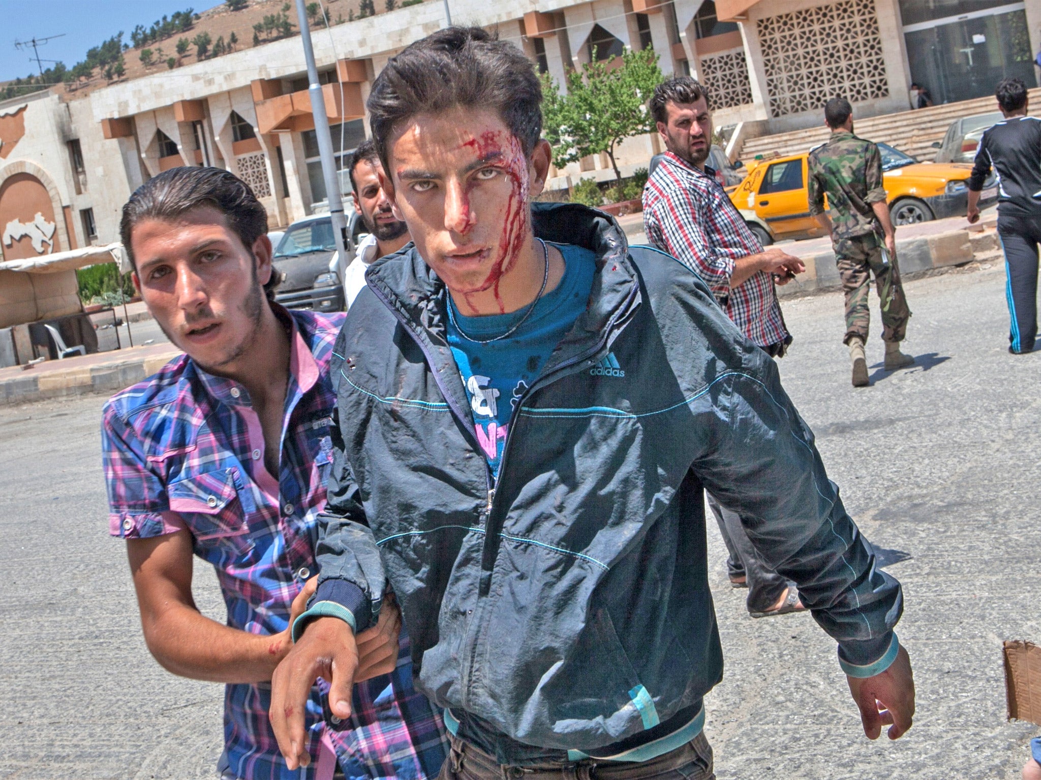 A wounded Syrian arrives for treatment at a hospital near the rebel-controlled border with Turkey