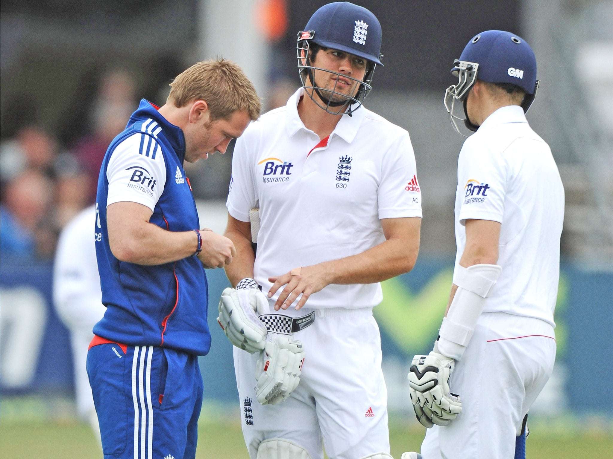 Alastair Cook is given treatment to a hand against Essex