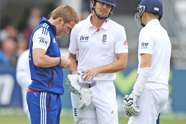 Alastair Cook is given treatment to a hand against Essex