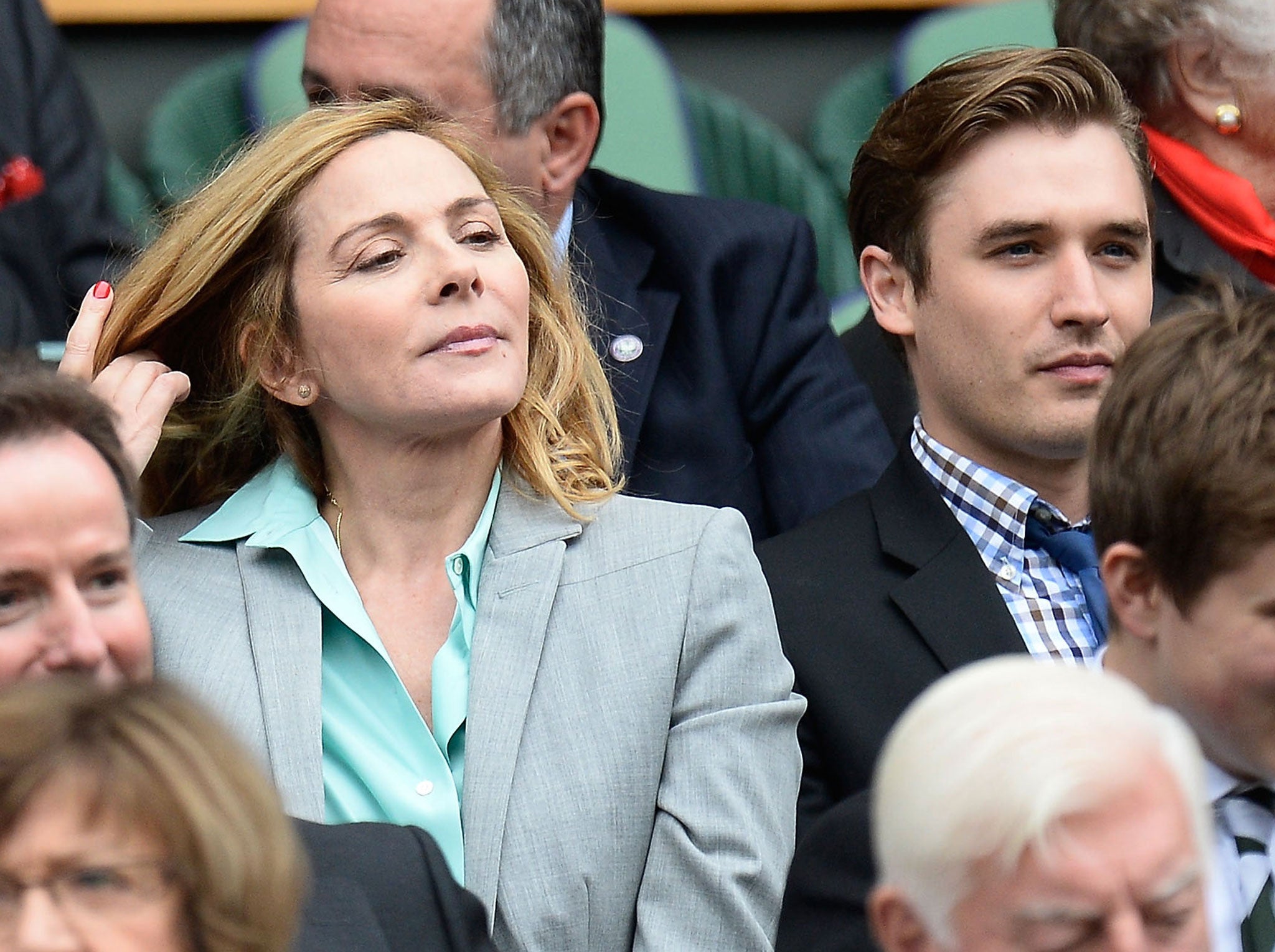 Kim Cattrall and Seth Numrich sit in the Royal Box before the Ladies' Singles quarter-final match between Agnieszka Radwanska of Poland and Na Li of China on day eight of the Wimbledon Lawn Tennis Championships at the All England Lawn Tennis and Croquet Club at Wimbledon on July 2, 2013 in London, England.