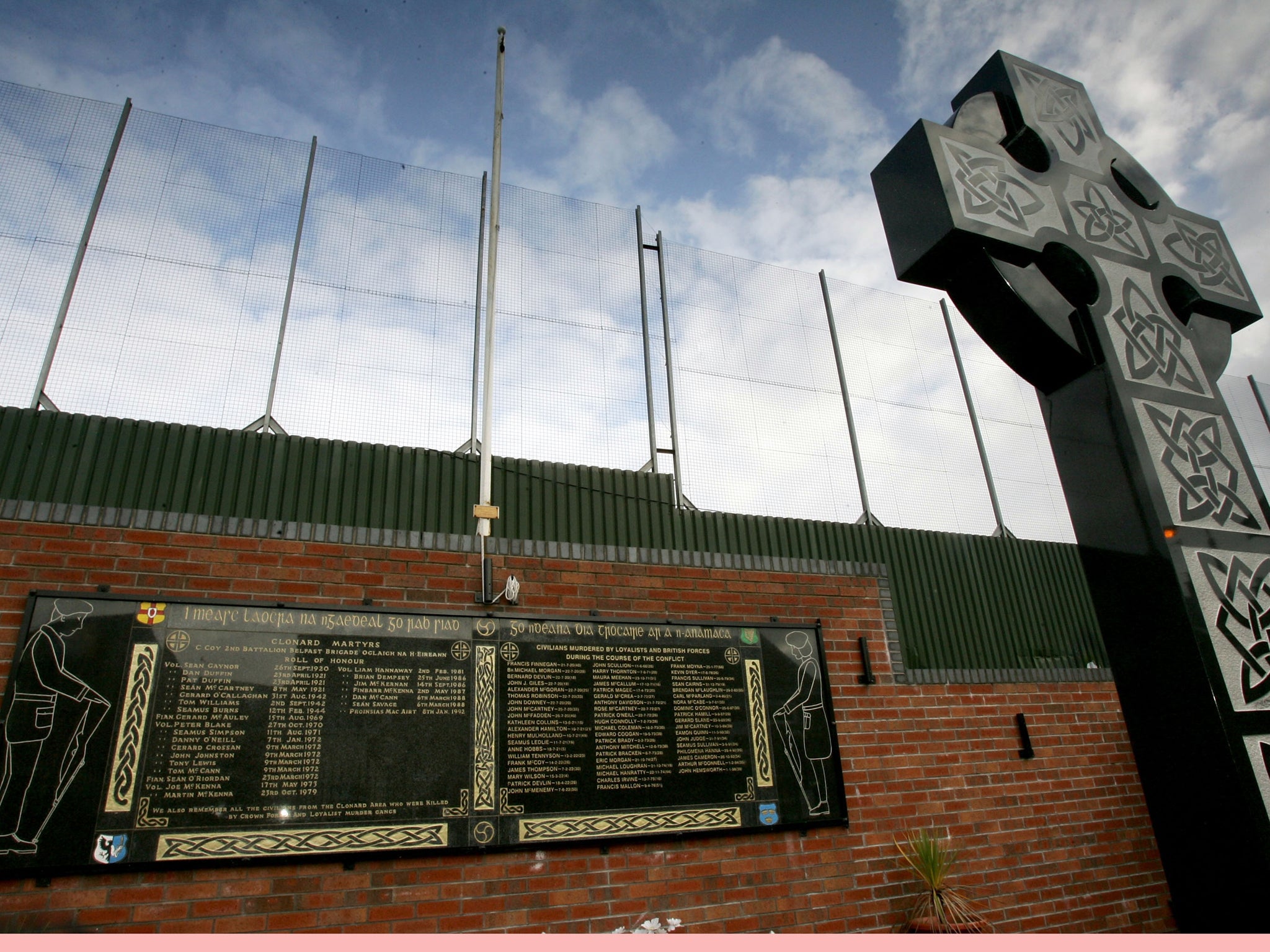 A memorial for IRA volunteers killed in 'the troubles' next to the Peace Line fence in Clonard republican area of West Belfast