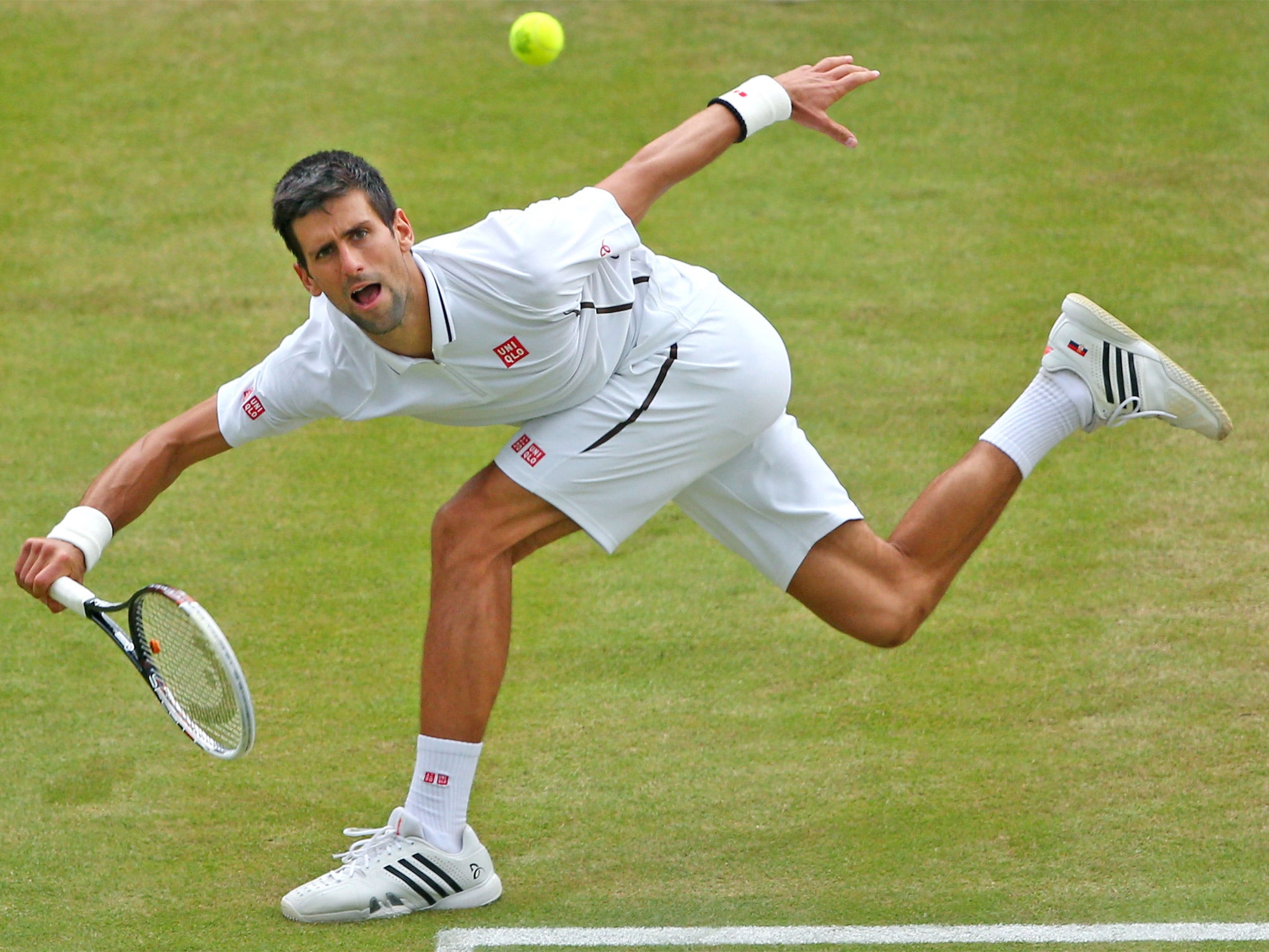 Novak Djokovic plays an awkward shot during his quarter-final victory over Tomas Berdych