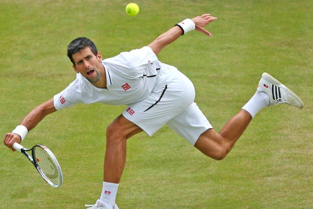 Novak Djokovic plays an awkward shot during his quarter-final victory over Tomas Berdych