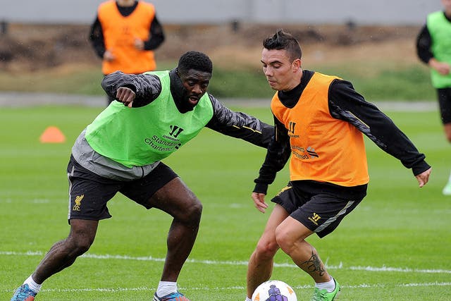 Kolo Toure and Iago Aspas of Liverpool in action during a training session at Melwood Training Ground 