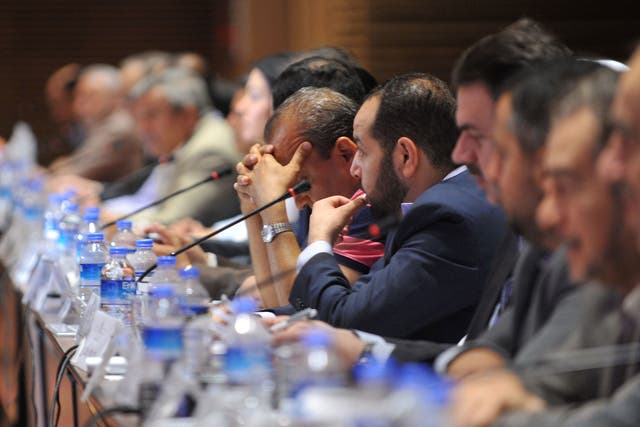 Members of the Syrian National Council (SNC) attend the National Coalition of Syrian Revolution and Opposition forces meeting