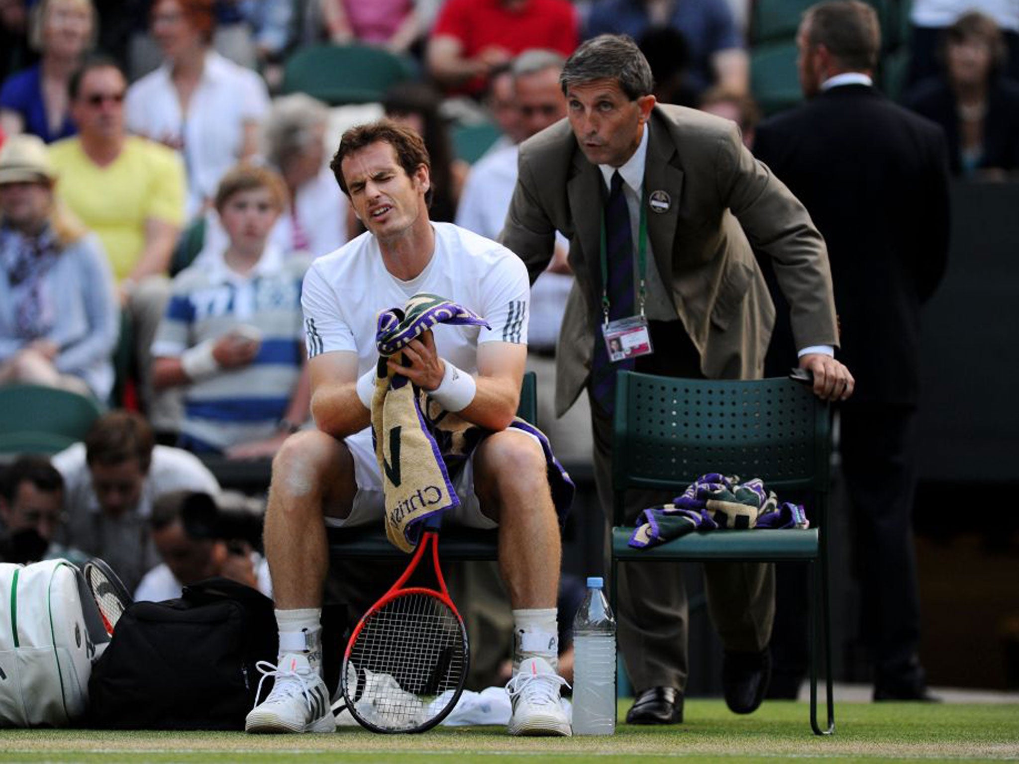 Andy Murray reacts as he is told by referee Andrew Jarrett about the decision to close the roof