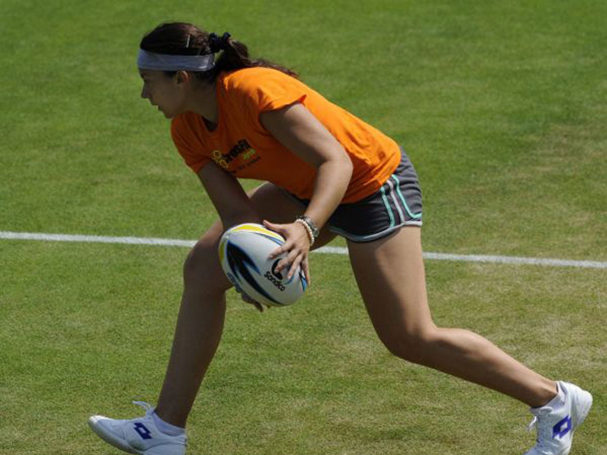 Marion Bartoli shows she is equally adept with a rugby ball in practice yesterday
