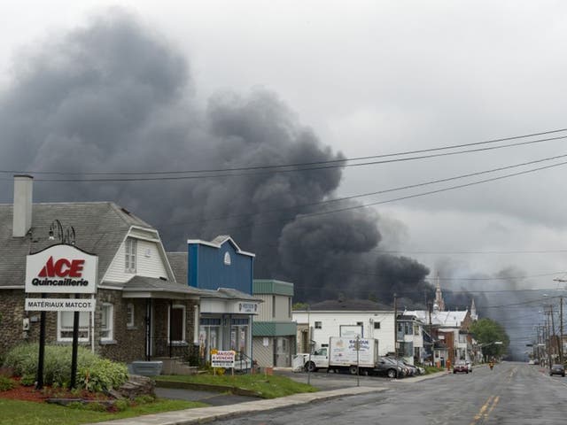 Smoke rises from railway cars that were carrying crude oil after derailing in downtown Lac Megantic, Quebec, Canada (AP)