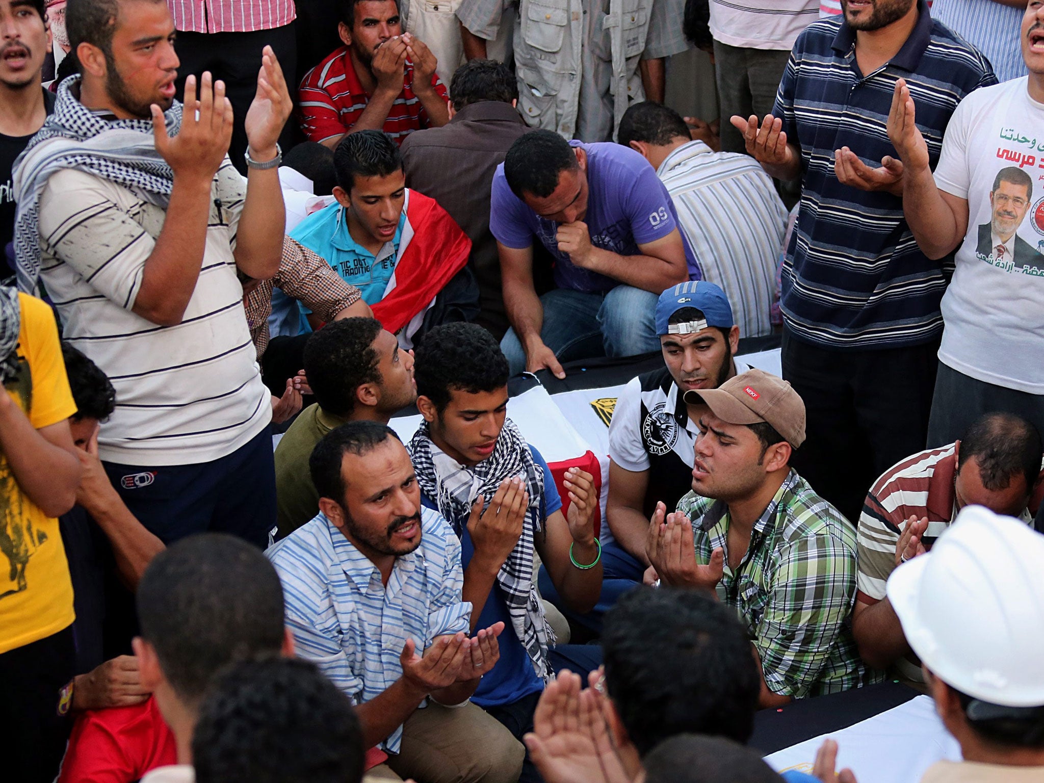 Morsi supporters yesterday at the funeral of seven people killed in the clashes