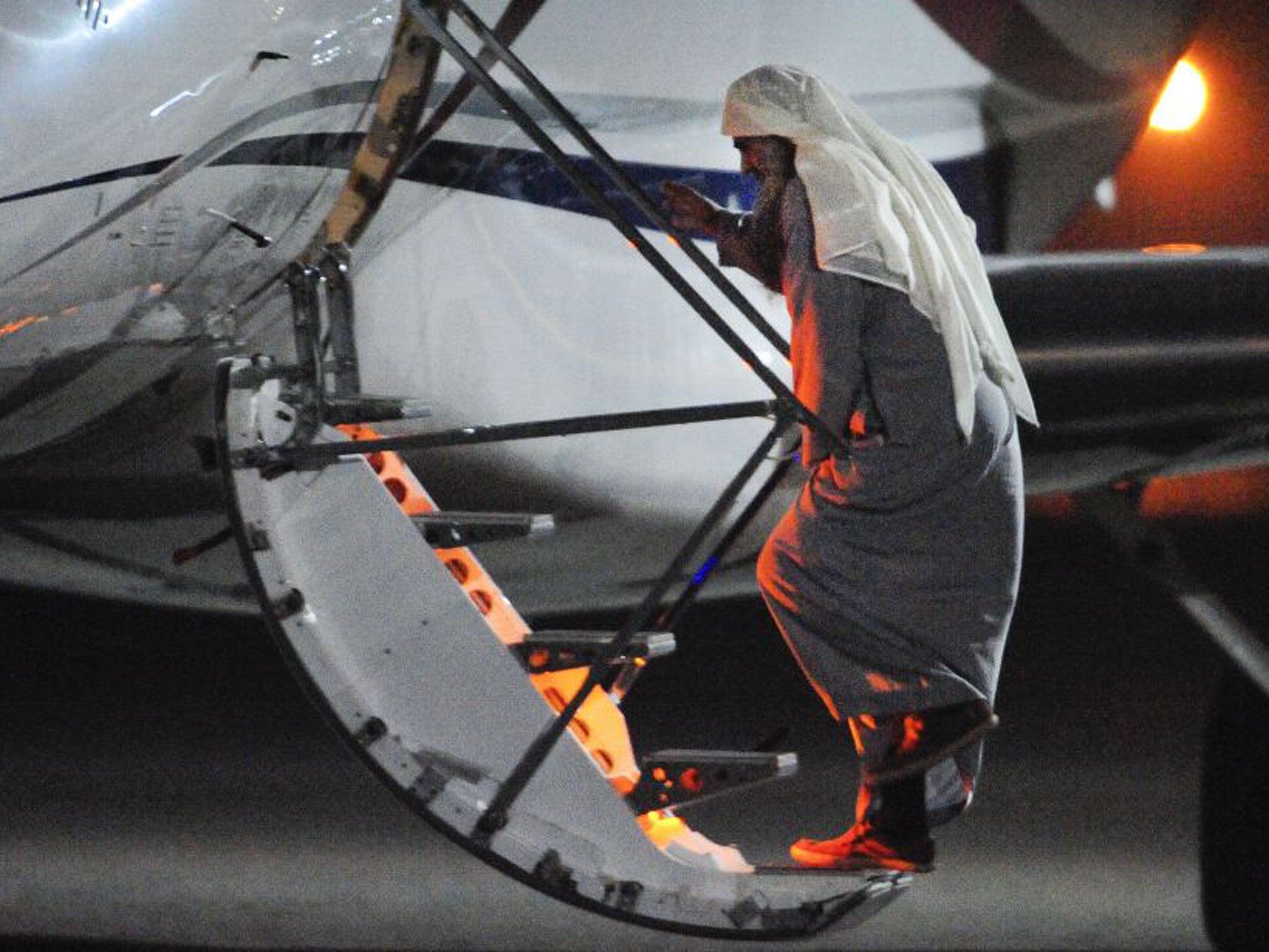 A photograph issued by the Ministry of Defence of Abu Qatada at RAF Northolt in West London boarding a private flight bound for Jordan