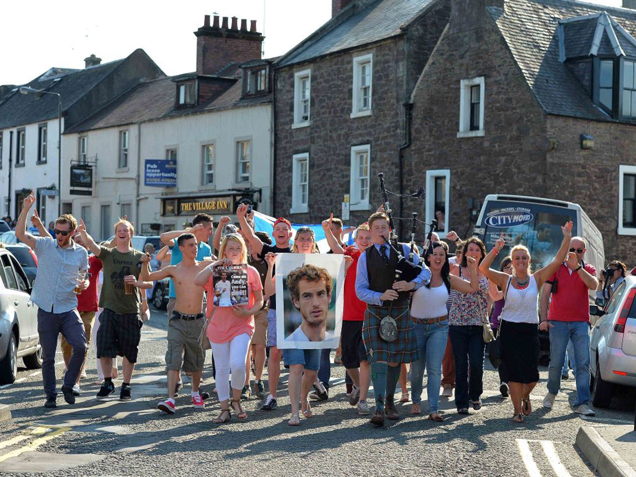 Dunblane residents take to the streets to celebrate after watching local boy Andy Murray of Great Britain beat Novak Djokovic of Serbia in the Wimbledon Men's Singles final
