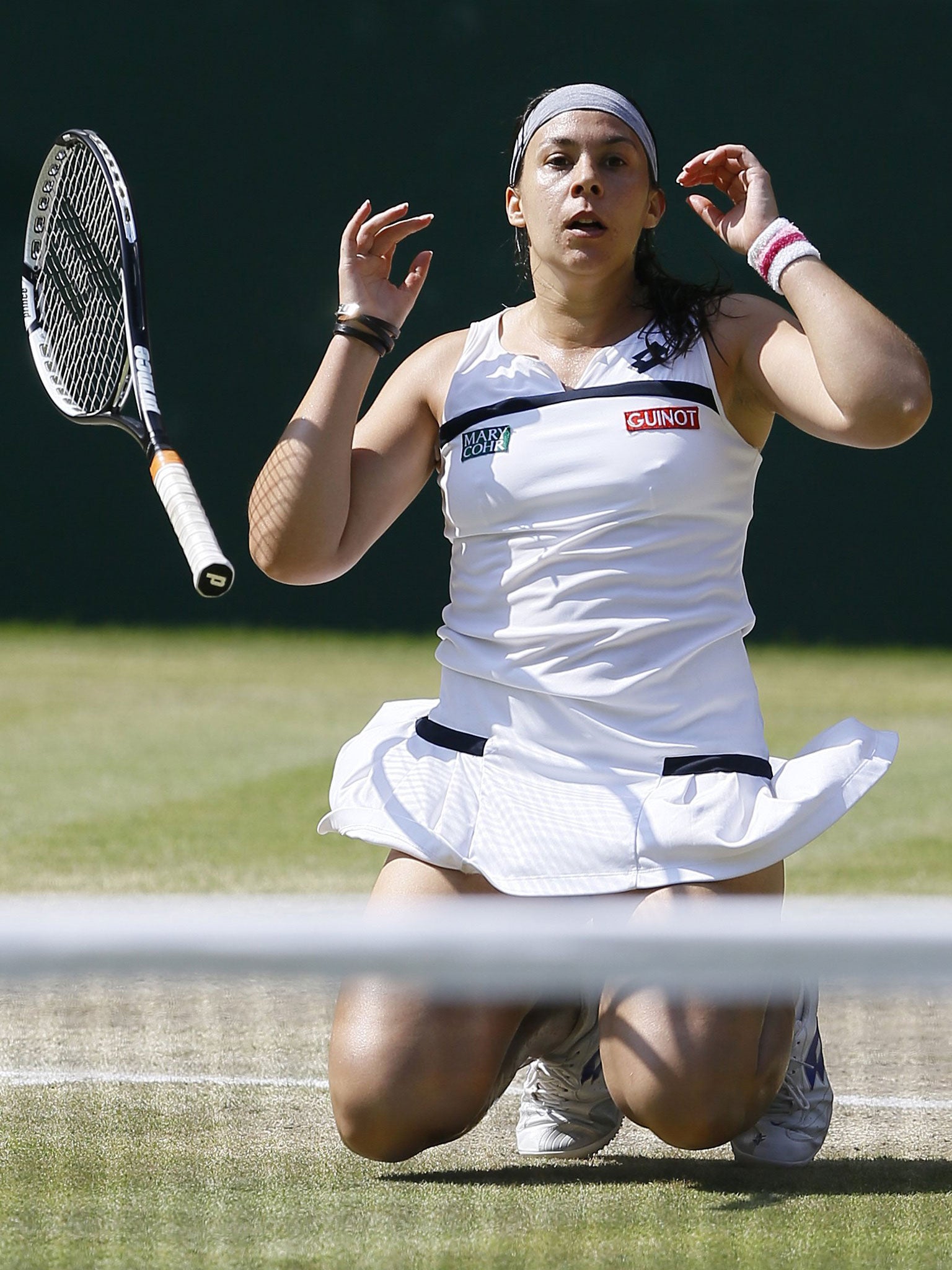 Marion Bartoli collapses to the ground after sealing her Wimbledon triumph over Sabine Lisicki