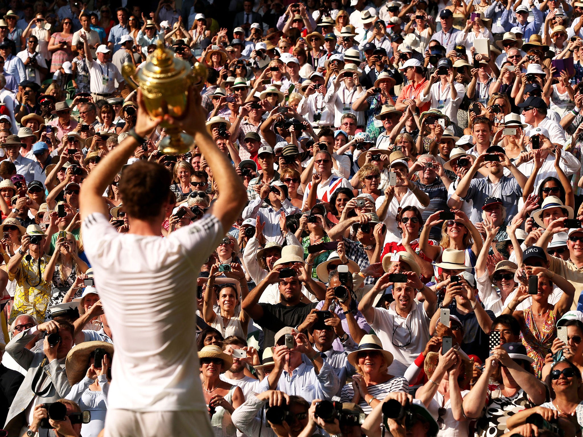 Andy Murray holds the trophy aloft for the fans on Centre Court