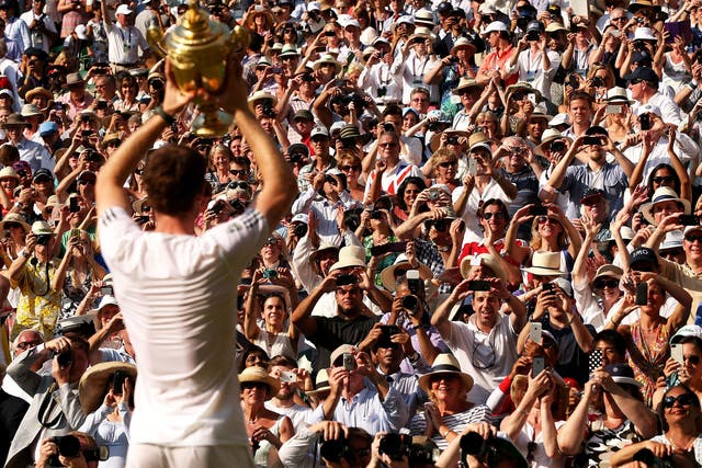 Andy Murray holds the trophy aloft for the fans on Centre Court