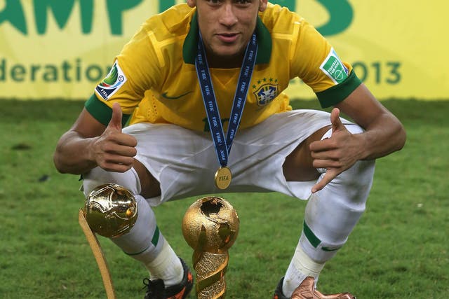 Neymar lines up the trophies after Brazil defeated Spain to win the Confederations Cup in Rio de Janeiro