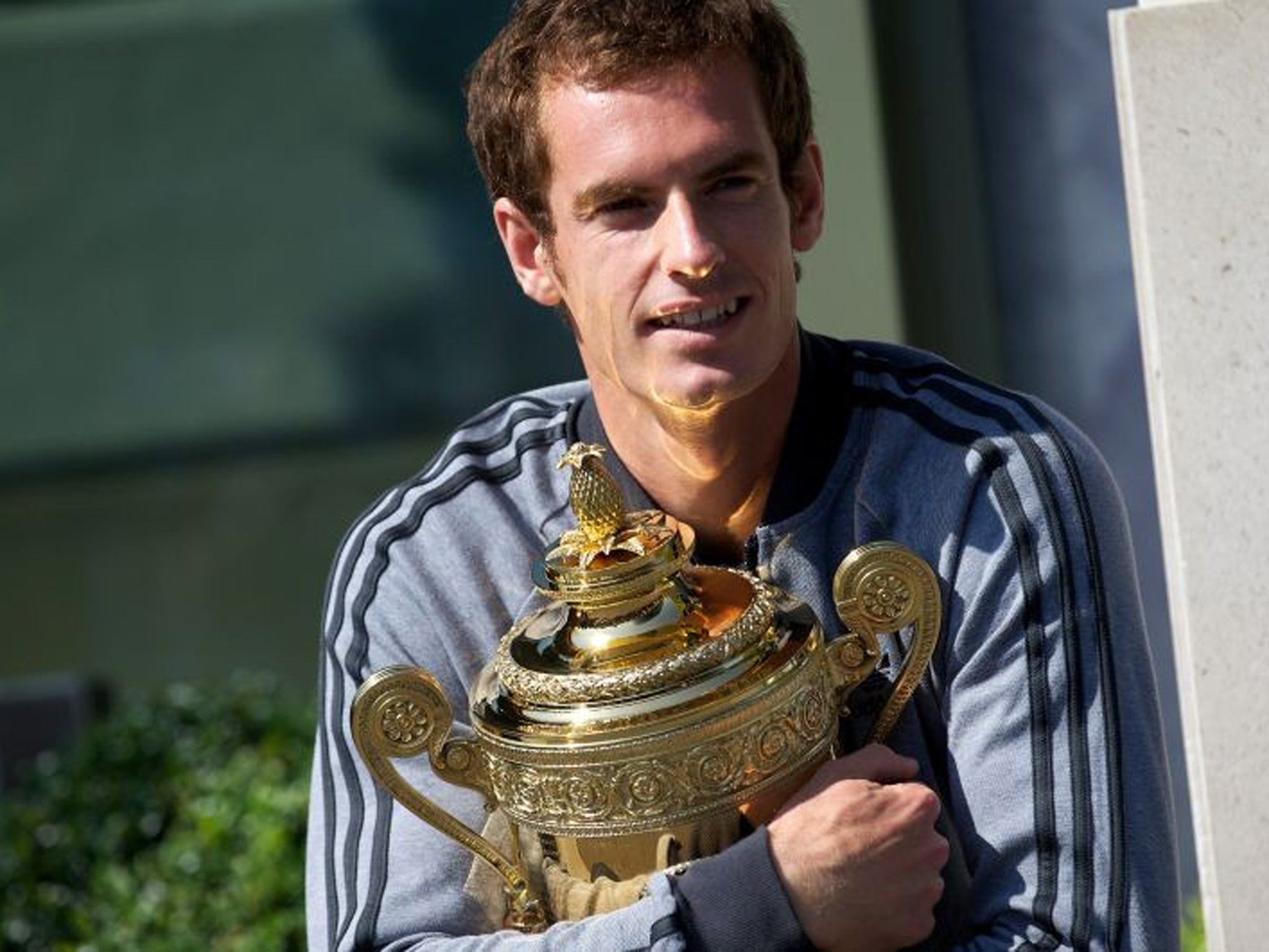 Andy Murray poses with the 2013 Wimbledon trophy at the All England Club in Wimbledon, a day after he won the men's singles final match against Novak Djokovic. Murray said he is determined to push on from his stunning Wimbledon win and add further Grand S